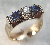 Diamond and sapphire ring with bridged mounting